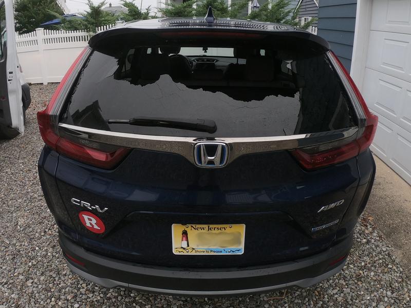 Shattered back glass on a Honda CR-V in a driveway, ready for a mobile rear window replacement